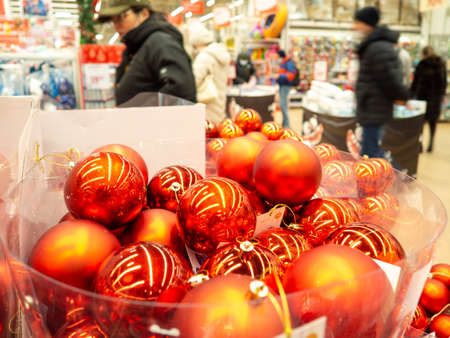 Christmas decorations in a box. Christmas sale. Preparing to dress up the Christmas tree. Bright decorations. Shop counter.の写真素材