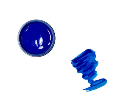 blue acrylic in a jar. drops of paint on the table. colorの写真素材