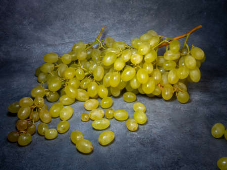 A large bunch of grapes on a black background. Husaini grapes. Still lifeの写真素材