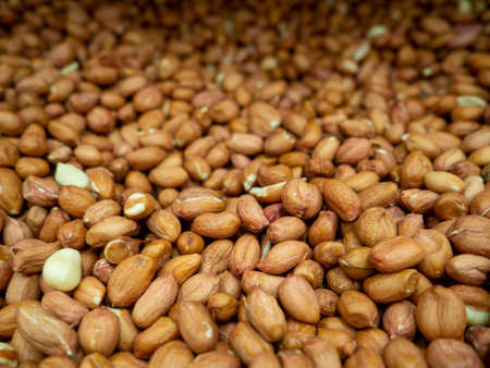 Peanut background. Healthy diet. Lots of nuts in the box. Peeled peanutsの写真素材