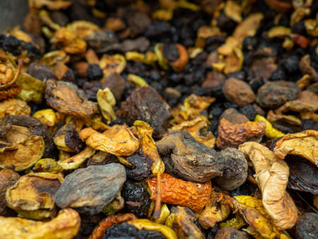Background from dried fruits. Lots of dried fruits. Diet. Filling for compote. Dried fruit box. Dried apple pieces, apricotsの写真素材