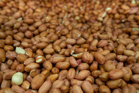 Peanut background. Healthy diet. Lots of nuts in the box. Peeled peanutsの写真素材