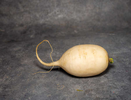 Daikon on a black background. large root, Japanese radish. Harvest, one root vegetableの写真素材