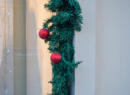 Christmas wreath on the wall. New Year's decoration on the street. Holiday atmosphereの写真素材