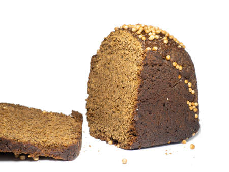 Sliced black bread sprinkled with coriander. Borodino bread. Flour product. Healthy food. Vegetarianism. Bread with spices on white backgroundの写真素材
