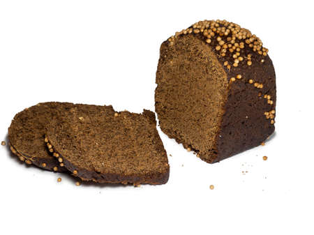 Sliced black bread sprinkled with coriander. Borodino bread. Flour product. Healthy food. Vegetarianism. Bread with spices on white backgroundの写真素材