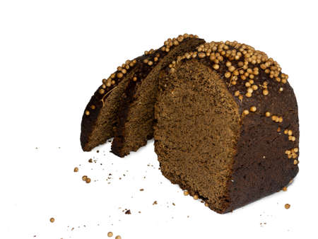 Sliced black bread sprinkled with coriander. Borodino bread. Flour product. Healthy food. Vegetarianism. Bread with spices on white backgroundの写真素材