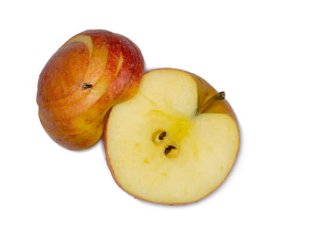 A large red apple cut into wedges. Fresh fruit isolate.Smoothly sliced ââapple wedges.A fly sits on an apple. Half of the fruit is cut.の写真素材