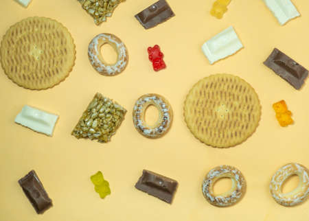 Background from different sweets. Sweets and flour products are scattered on the table. Unhealthy foodの写真素材