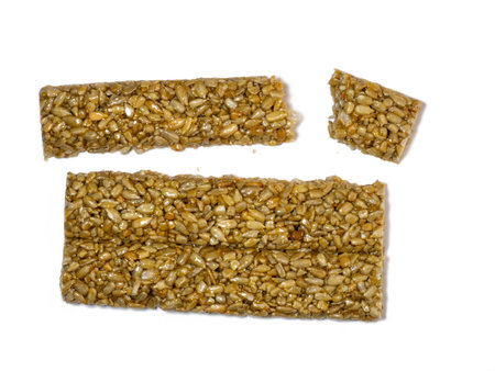 Kozinaki tile. Pressed sunflower seeds in honey on a white background.の写真素材