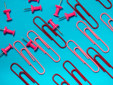 Office work. Colored paper clips. Colored paper with staples. Work with documents.  Colorful office supplies.の写真素材