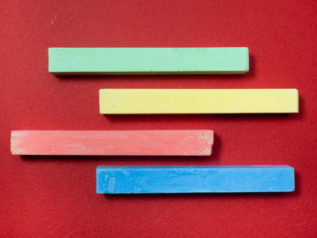 colorful crayons on a red background. Drawing accessories. Artist Toolsの写真素材