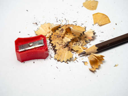 Artist's workshop. School supplies. Pencil sharpening. Multicolored pencils. Wood and graphite shavings. The process of preparing for work. Creative messの写真素材