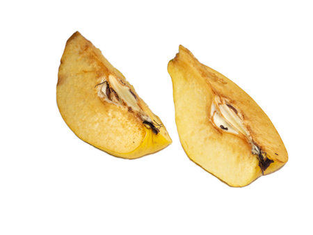 chopped quince. Juicy fruits on a white background. Ripe useful product. Fruit quarters. weathered fruit pulp. diet food. darkening of cut fruitの写真素材
