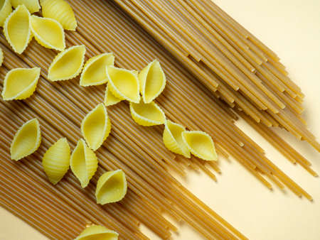 Spaghetti of two types on the table. shells and buckwheat pasta. Italian food. Long pasta. Cooking food. durum wheatの写真素材