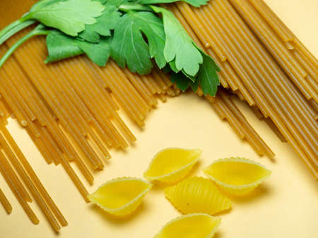 Spaghetti of two types on the table. shells and buckwheat pasta. Italian food. Long pasta. Cooking food. durum wheatの写真素材