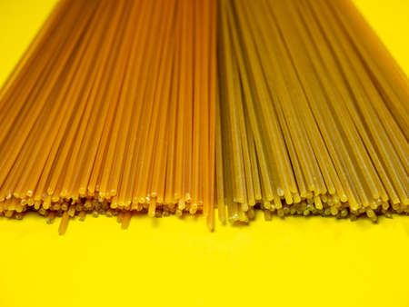 Pasta of two types on the table. Tomato and buckwheat spaghetti. Italian food. Long pasta. Cuisine of the peoples of the world. Cooking food. durum wheatの写真素材