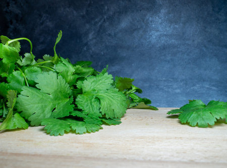 Parsley on the table. Useful product. Greens on a cutting board. Vegetarian lunch ingredient. Lots...