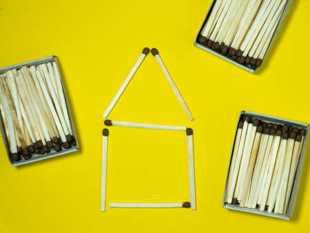 Matchsticks on a yellow background. Safe handling of fire. Fire dangers. Lots of matches. Danger. household still life. Pictures lined with matchesの写真素材
