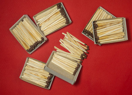 Matchsticks on a red background. Safe handling of fire. Fire dangers. Lots of matches. Danger.household still life. Matchsticks  boxesの写真素材