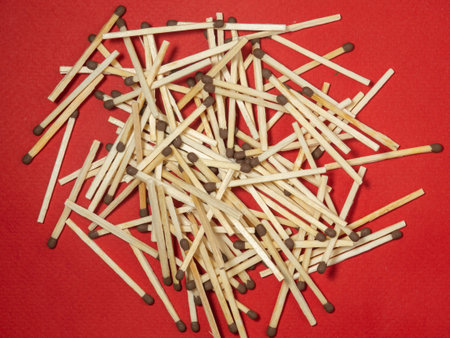 Matchsticks on a red background. Safe handling of fire. Fire dangers. Lots of matches. Danger.household still lifeの写真素材