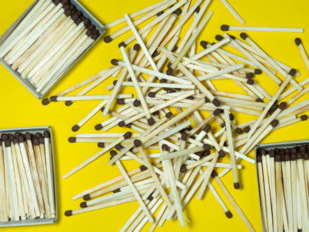 Matchsticks on a yellow background. Safe handling of fire. Fire dangers. Lots of matches. Danger. household still life.の写真素材