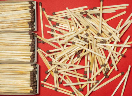 Matchsticks  on a red background. Safe handling of fire. Fire dangers. Lots of matches. Danger.household still lifeの写真素材