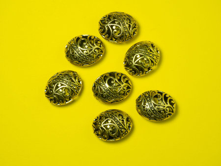 Beads. Jewelry on a yellow background. Jewelry alloy. antique gold. beautiful decoration