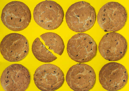Oatmeal cookies on a yellow background. Cookies with raisins on the table. Background. Sweet treat. food for breakfastの写真素材