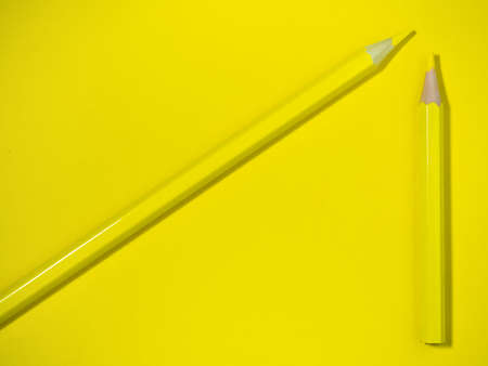 Yellow wooden pencil on yellow paper. sharpened pencils. drawing tool. painting. Accessories for creativity.の写真素材