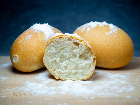 bakery products. Table in the bakery. White bun on a cutting board. Products from wheat flour of the...