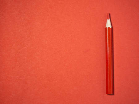 red wooden pencil on red paper. sharpened pencils. drawing tool. painting. Accessories for creativity.の写真素材