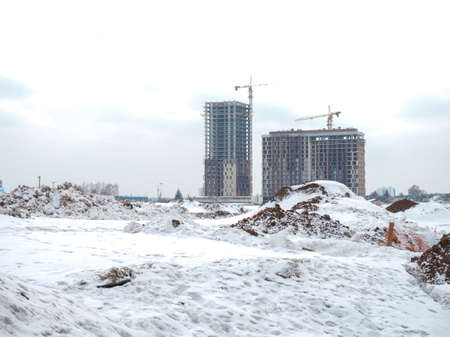 Construction of high-rise buildings in winter. high cranes. construction. Concrete building framesの写真素材
