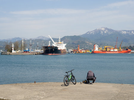 Batumi, Georgia. 04.20.2022 Girls on the pier. Sea coast. Port within the city. rocky shore. children by the seaのeditorial素材