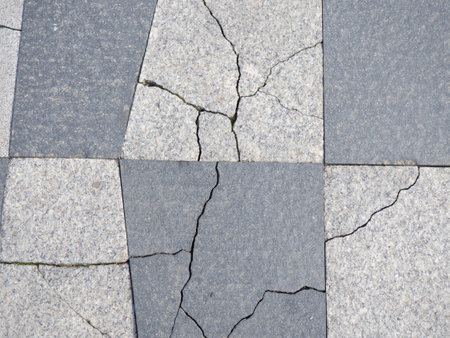 Cracks in pavement tiles. masonry. The texture of the flooring. Tiles on the ground in the streetの写真素材
