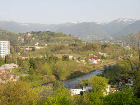 View from a height of the city and mountains. Suburb of a southern city and mountains in the background.の写真素材