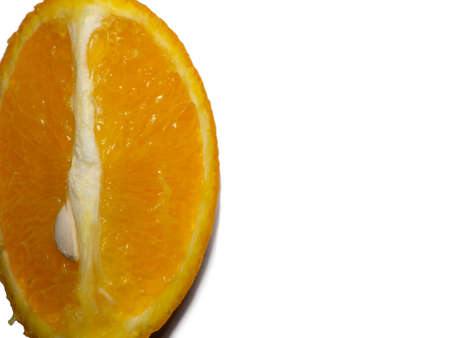 Slice of orange on a white background. fruit isolate. Juicy orange on the table. Cooking food and drinks. Sliced ââjuicy fruit with a seed in the pulpの写真素材