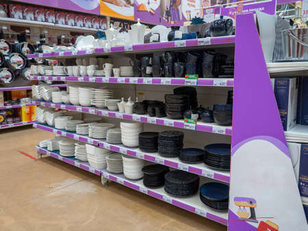 Shelves in the store. Sale of dishes. kitchenware. Laying out goods in a supermarket. Tradeの写真素材