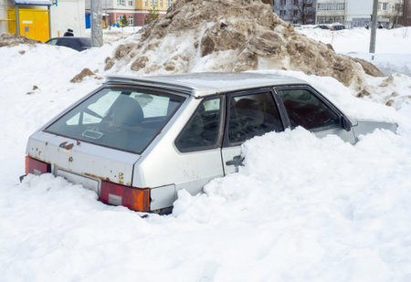 the car got stuck in the snow. Left for the winter under the snow. abandoned car.の写真素材
