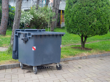 Garbage container in the park. Fight for the environment. Garbage bin among green trees. Natureの写真素材