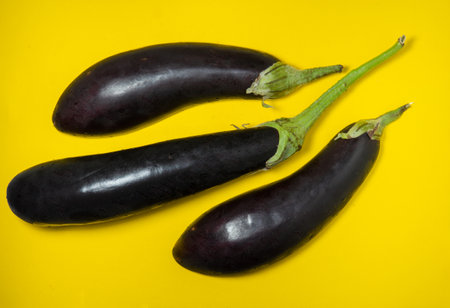 eggplant on a yellow background. Vegetables on the table. beautiful eggplant. common vegetable. Cooking.の写真素材