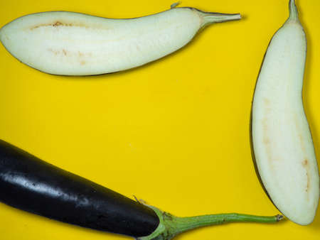 Sliced ââeggplant on a yellow background. Vegetables on the table. beautiful eggplant. common vegetable. Cooking.の写真素材