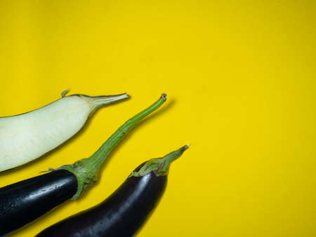 Sliced ââeggplant on a yellow background. Vegetables on the table. beautiful eggplant. common vegetable. Cooking.の写真素材