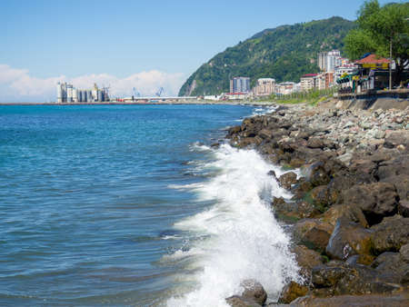 Surf. Waves crash on big rocks. rocky coast and wave. fortified coastline. View of the Turkish cityの写真素材