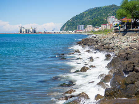 Surf. Waves crash on big rocks. rocky coast and wave. fortified coastline. View of the Turkish cityの写真素材