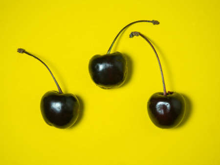 Sweet cherry on a yellow background. bright table. Berries on the table. harvest. delicious foodの写真素材