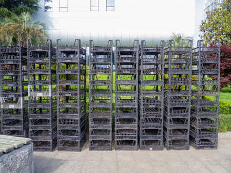 Stacked boxes on top of each other. Plastic seedling boxes. Empty containers on the streetの写真素材