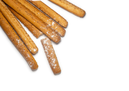 Sesame biscuits on a white background. Biscuits are elongated in the form of sticks. Bread products....