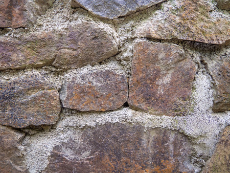 ancient stonework. The stones are reinforced with old mortar. Uneven masonry ancient wall. Grayの写真素材
