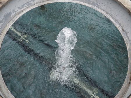 A jet of water in a fountain. Top view of fountain water flow. spray. Loving liquidの写真素材